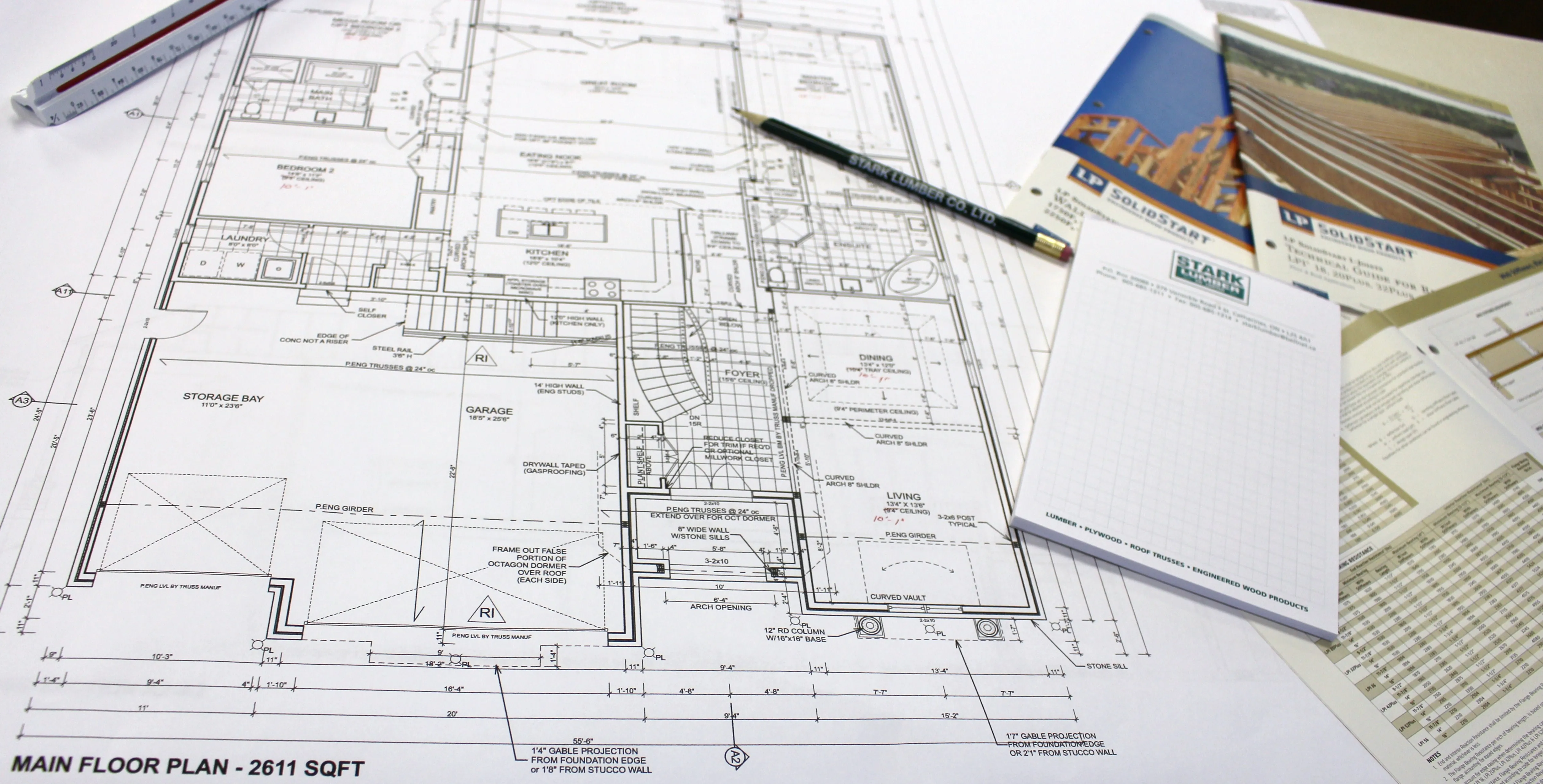 House plans on a design desk with a Stark Lumber pencil