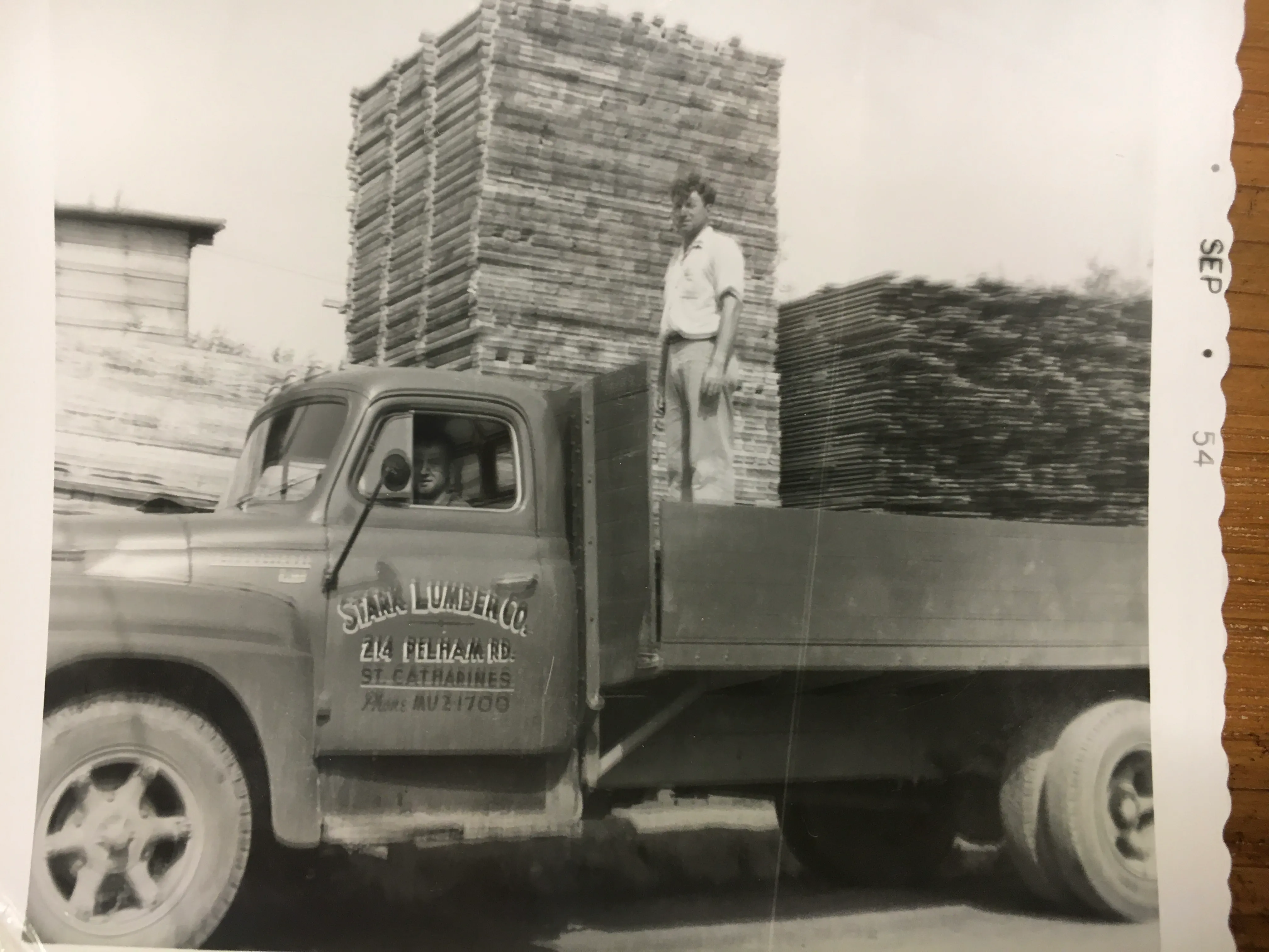 A Stark Lumber delivery truck stacked high with lumber, photographed in September 1954